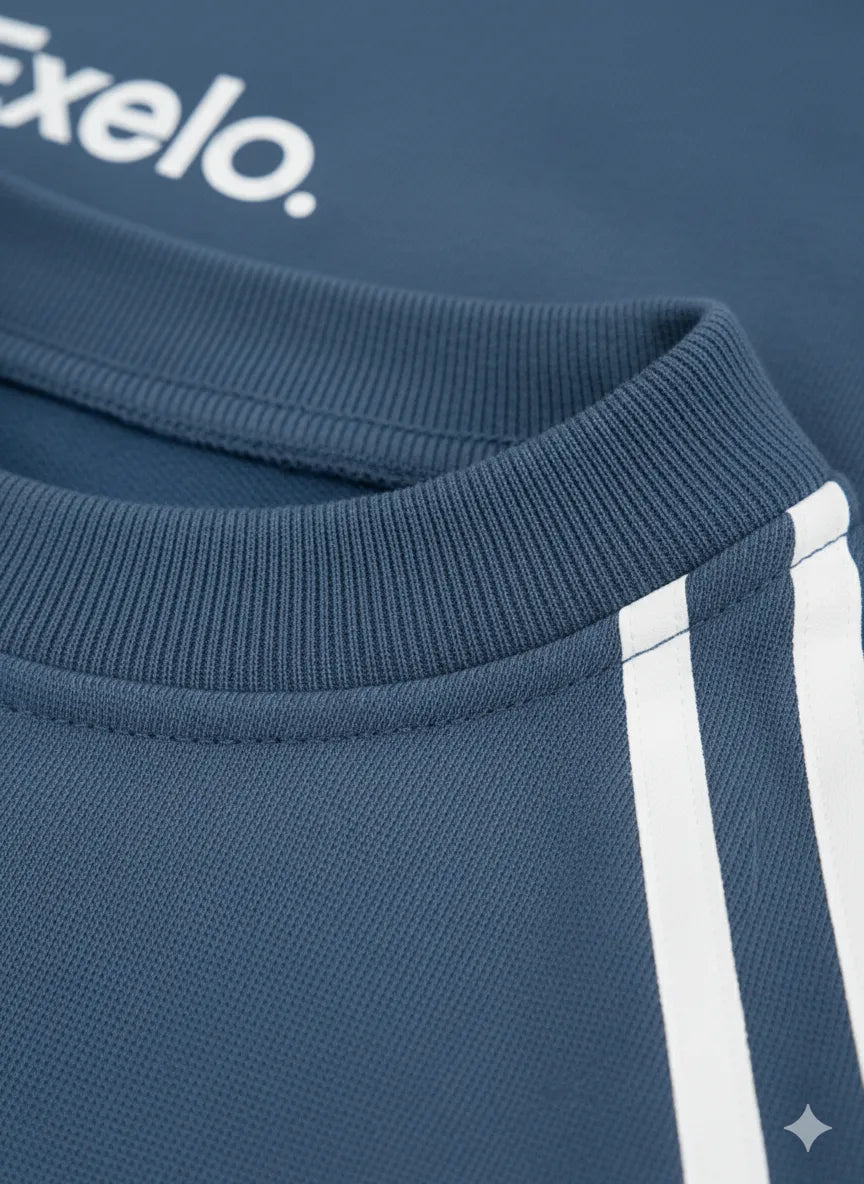 Close-up of a blue garment with 'Exelo' branding on a dark background